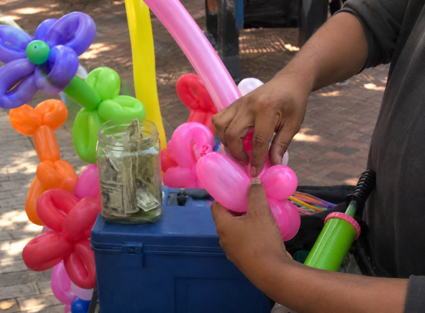 Balloon animal being twisted by a balloon artist
